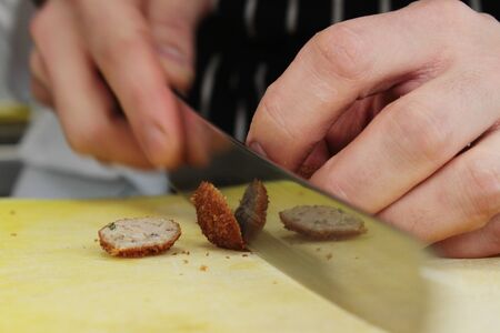 chef cooking and preparing plated mealの写真素材