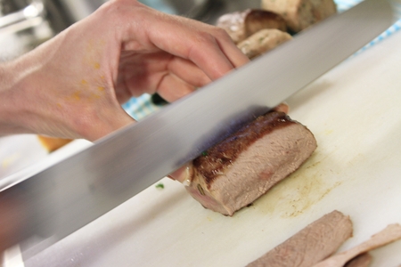 chef cooking and preparing plated mealの写真素材