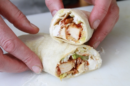 chef preparing chicken wrapの写真素材