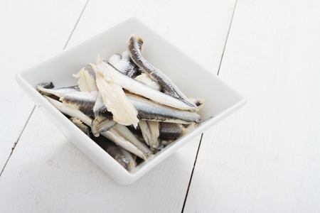 pickled anchovies in white dishの写真素材