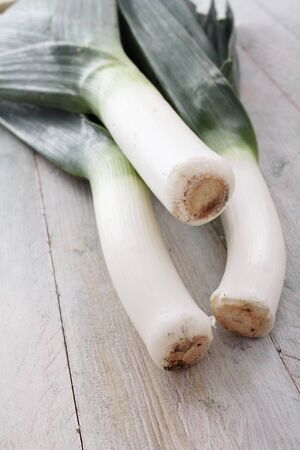 fresh leeks on wooden tableの写真素材