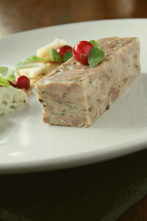 plated pork terrine starter with cranberriesの写真素材