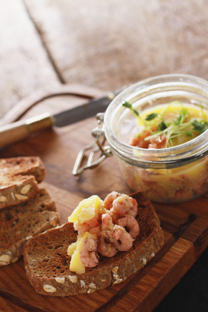 traditional potted shrimp appetizer served with toasted brown breadの写真素材