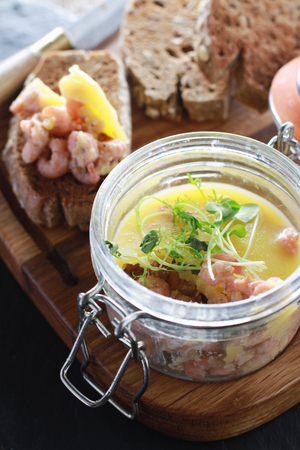 traditional potted shrimp appetizer served with toasted brown breadの写真素材