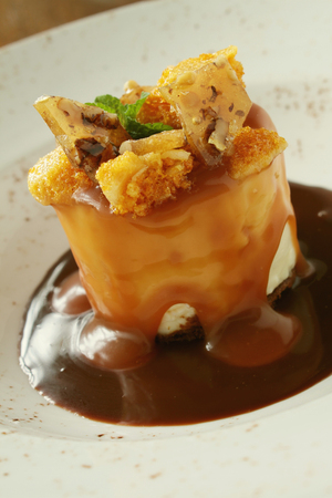 plated toffee cheesecake dessert with cinder toffeeの写真素材