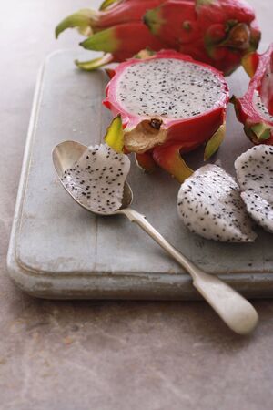 fresh sliced dragonfruit on chopping boardの写真素材