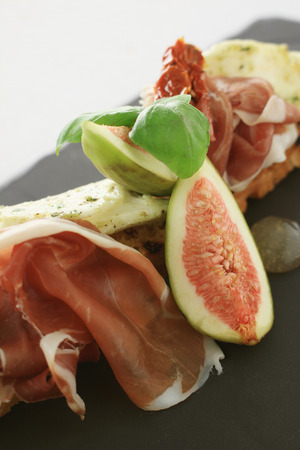 fig and cured ham bruschetta  appetizer starterの写真素材