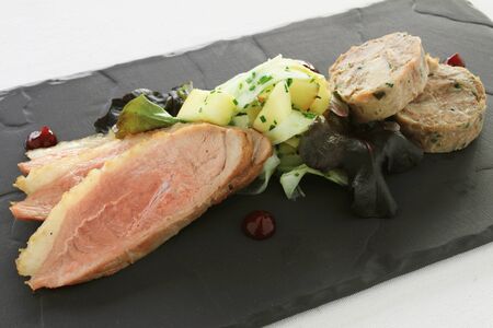plated  duck and pork appetizer meal mainの写真素材