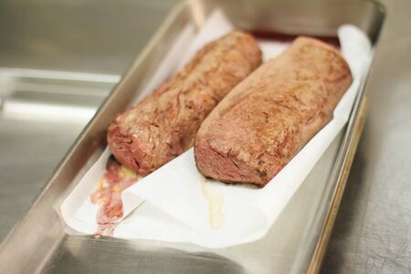 cooked beef fillet steak resting on trayの写真素材