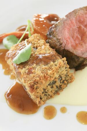 gourmet beef fillet plated meal with roasted vegetablesの写真素材