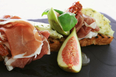 fig and cured ham bruschetta  appetizer starterの写真素材