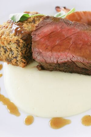 gourmet beef fillet plated meal with roasted vegetablesの写真素材