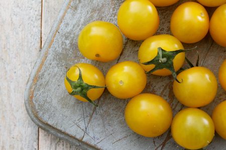 preparing small yellow tomatoesの写真素材