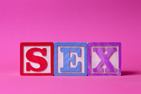 Alphabet blocks spelling sex over pink backgroundの写真素材