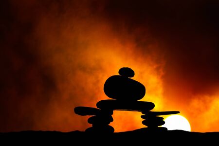 Rock Cairn with Setting or Rising Sunの写真素材