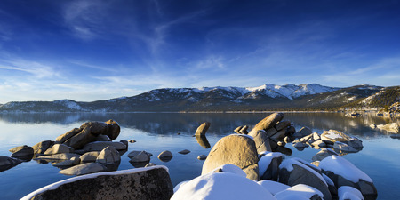 Winter shot of Lake Tahoe with snow on rocks and mountains. Sand Harbor Nevadaの写真素材