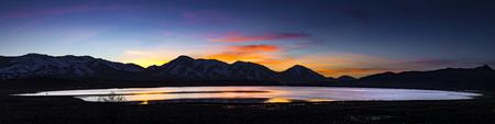 Desert lake, flooded playa at Sunset with mountain ranges and colorful clouds.  White Lake,  Cold Springs, Nevadaの写真素材