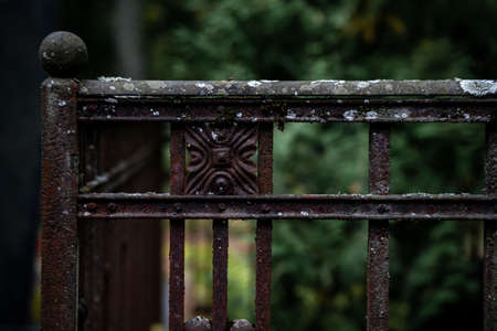 old classic iron or cast iron fence in Latvia cemetery. Traditional grave places in Europe are fenced with high bordersの写真素材