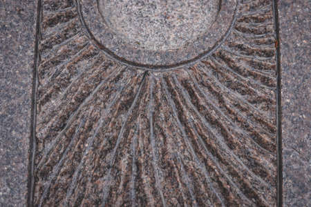 pattern of wet carved engraved brown granite surface, excentric lines, round polished line, symmetric detailの写真素材