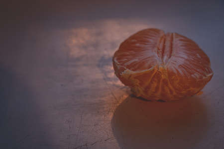 Mandarin orange on white table, sunlight from windowの写真素材