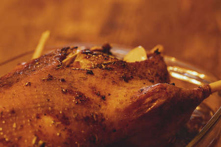 roast duck with spices in a frying pan, close-up, selective focus, filled with onion ringsの写真素材