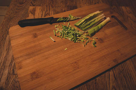Natural fresh cutted leeks on the wooden cutting boardの写真素材