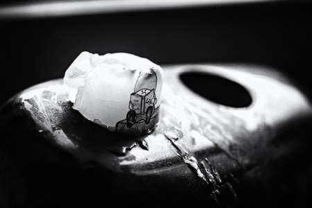 one old candle in polished stone with holes for candles. Latvian candlestone made from granite rock. Monochrome black and whietの写真素材