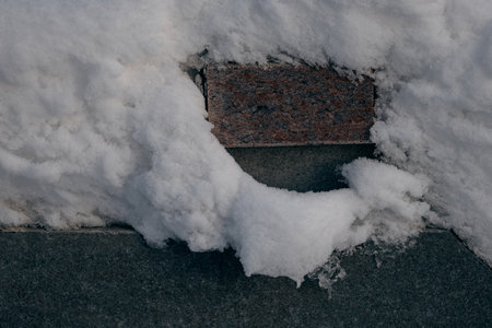Close-up of a stone  in winter. Snow on the stone slateの写真素材