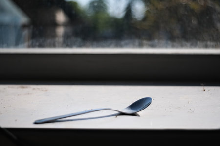 spoon in dirty windowsill, shallow depth of field.の写真素材
