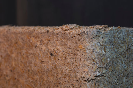 Close-up of a wood briquettes, pressed sawdust on a dark background. Solid fuel from wood chips and...
