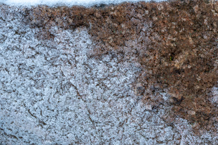 Close up of a stone wall covered with snow. Natural background.の写真素材