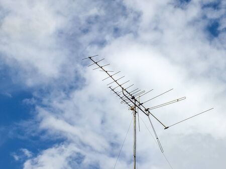 a old tv antenna with blue skyの写真素材