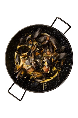 Prepared mussels in black saucepan isolatedの写真素材