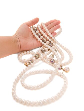 Hand holding pearl jewel isolatedの写真素材