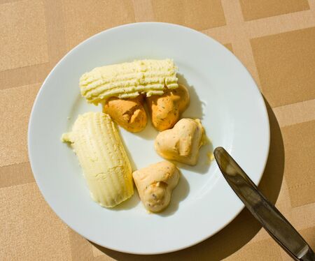 assortment of butter slices on white plateの写真素材
