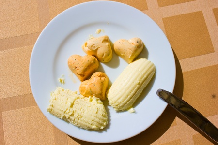 assortment of butter slices on white plateの写真素材