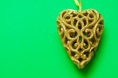 christmas decorations of golden heart  on green backgroundの写真素材