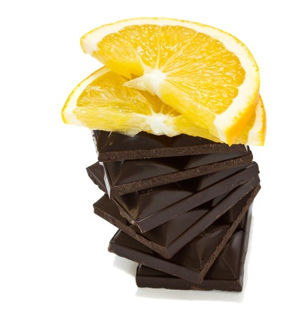 dark chokolate bar with orange slice isolated on white backgroundの写真素材