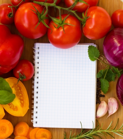 blank notebook for recipes with colorful vegetablesの写真素材