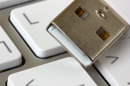 white keyboard and usb devise close up