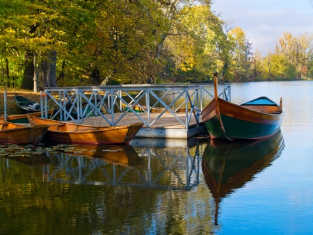 boats near pier at lake autumn day in parkの写真素材