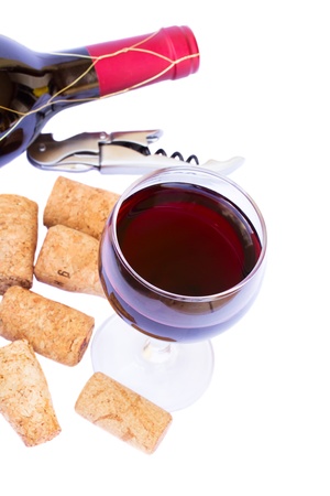 bottle and glass of  red wine with corks  isolated on white backgroundの写真素材