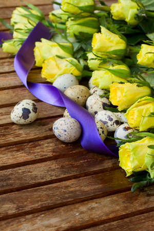  yellow  roses with quail eggs for easterの写真素材