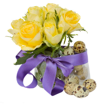 easter quail eggs and roses with blue ribbon isolated on white の写真素材