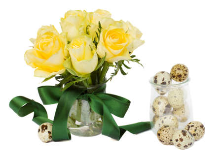 easter eggs and yellow roses  isolated on white の写真素材