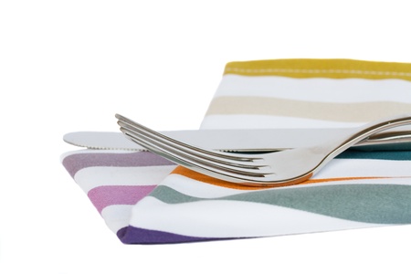 knife and fork close up on napkin isolated on white 