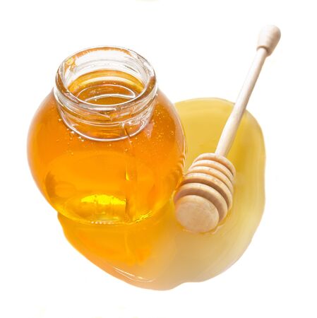  jar full of honey and stick isolated on white background の写真素材