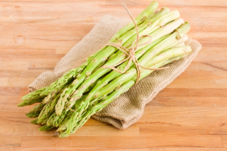fresh green asparagus sprouts  on wooden tableの写真素材