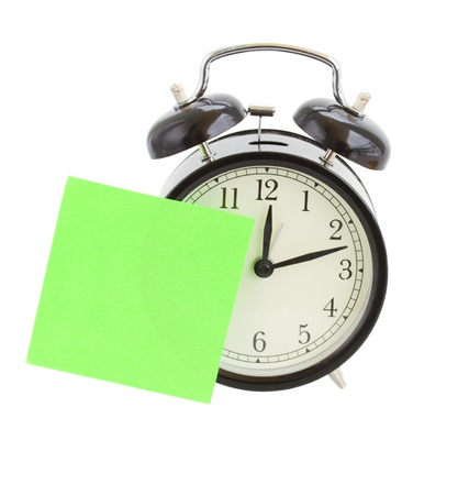 alarm clock with empty  note isolated on white backgroundの写真素材