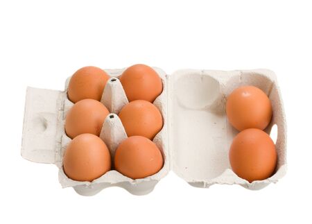 open box of raw brown eggs isolated on white backgroundの写真素材